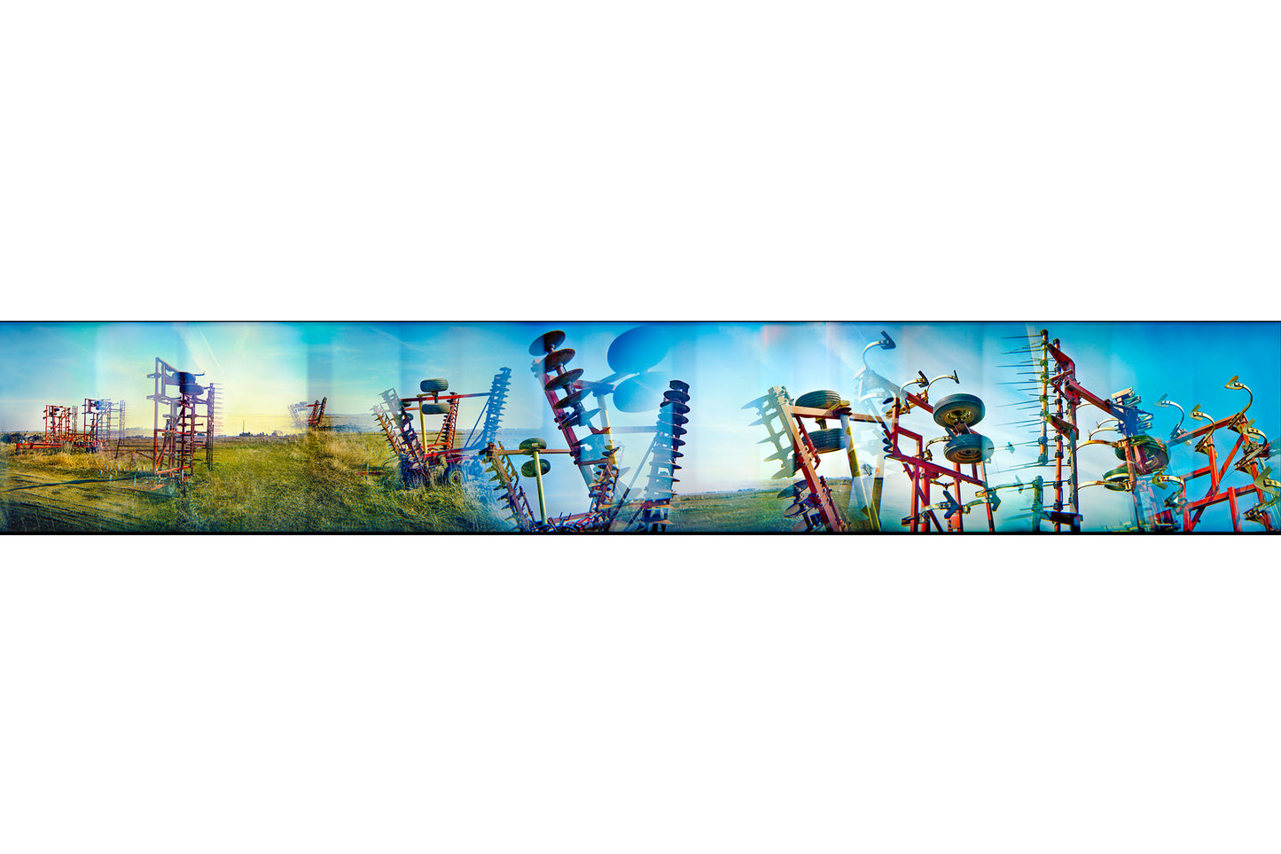 Overlapping multiple exposure shot on film of farm equipment silhouetted in sky