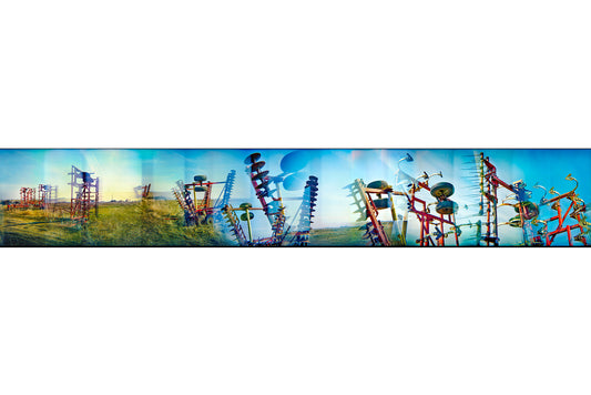 Overlapping multiple exposure shot on film of farm equipment silhouetted in sky