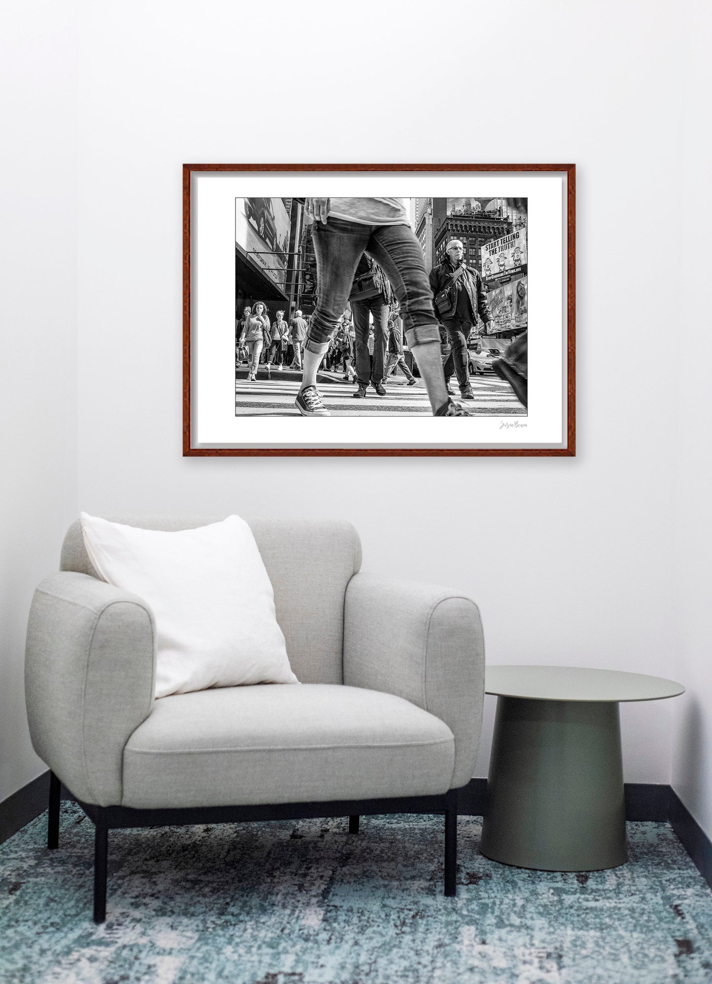 Black & White photograph of people walking in Times Square with low perspective