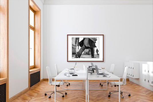 Black & White photograph of people walking in New York City with low perspective