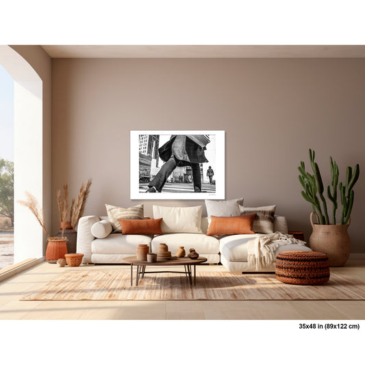 Canal Street Looming Figure artwork by Susan Bowen, shown as 35x48 print. Features low-angle B&W photograph of a figure mid-stride at Canal Street, coat billowing, dwarfing the city behind them.