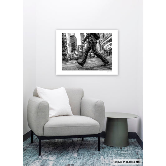 Times Square Stride artwork by Susan Bowen, shown as 24x33 print. Features b&W street photograph of a blurred stride crossing Times Square, boots and billboards in sharp contrast.