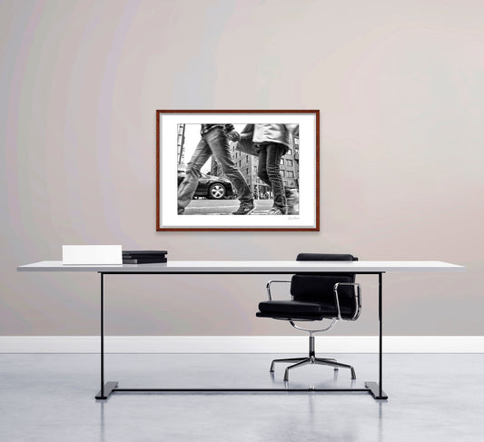 Black & White photograph of people walking in New York City with low perspective