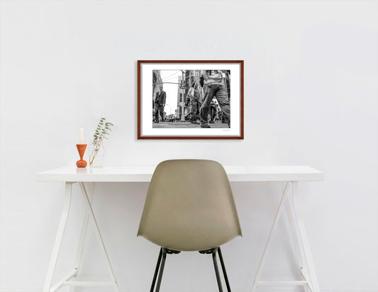 Black & White photograph of people walking in Times Square with low perspective