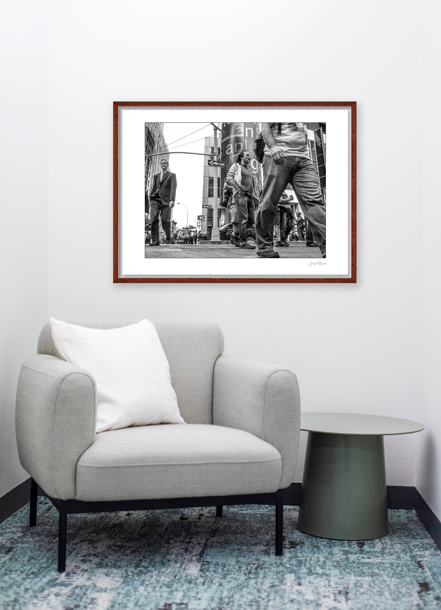 Black & White photograph of people walking in Times Square with low perspective