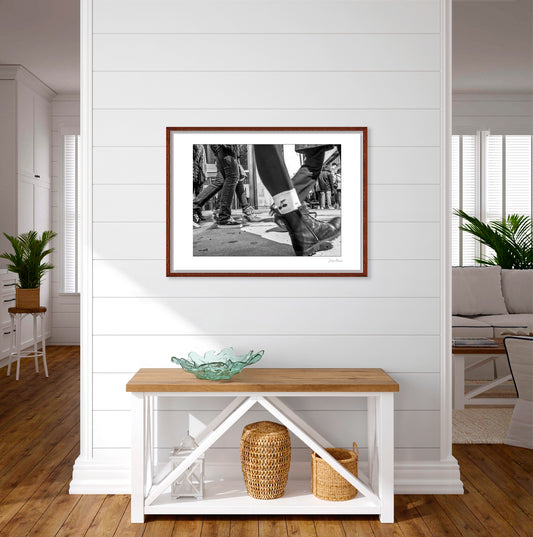 Black & White photograph of people walking in Times Square with low perspective