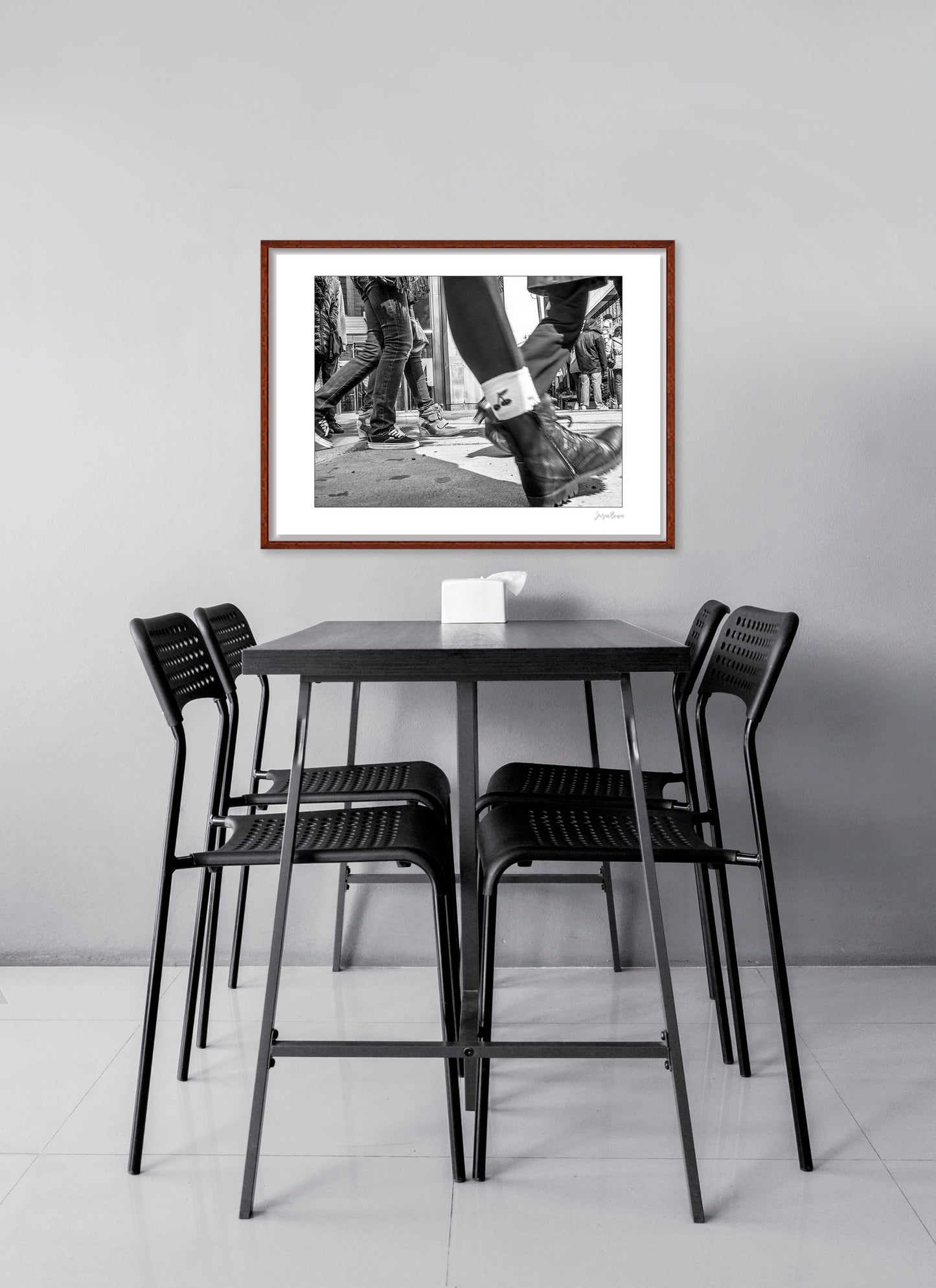 Black & White photograph of people walking in Times Square with low perspective