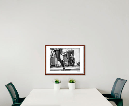 Black & White photograph of people walking in New York City with low perspective