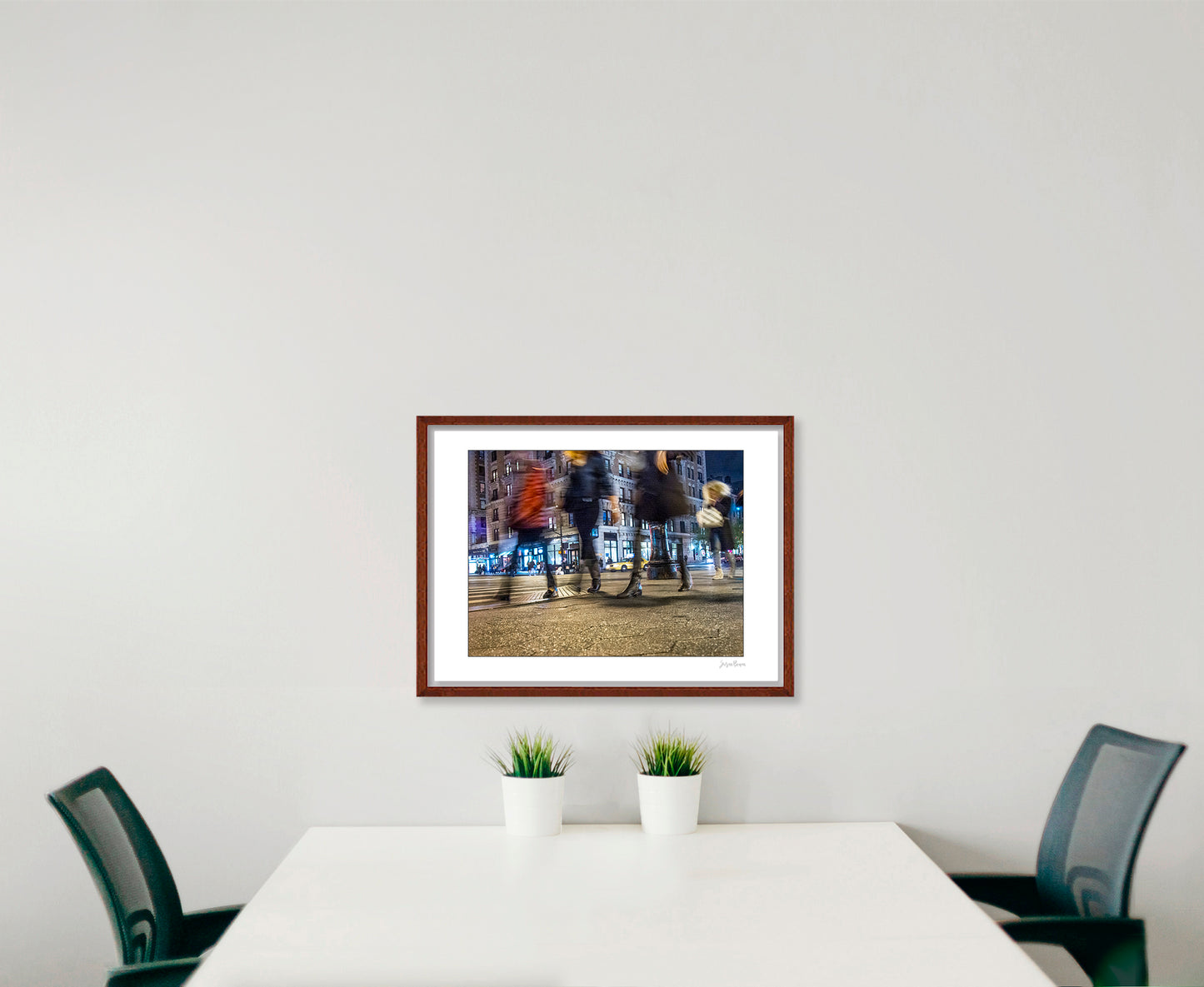 Photograph of 4 blurry people walking at night in New York City with low perspective