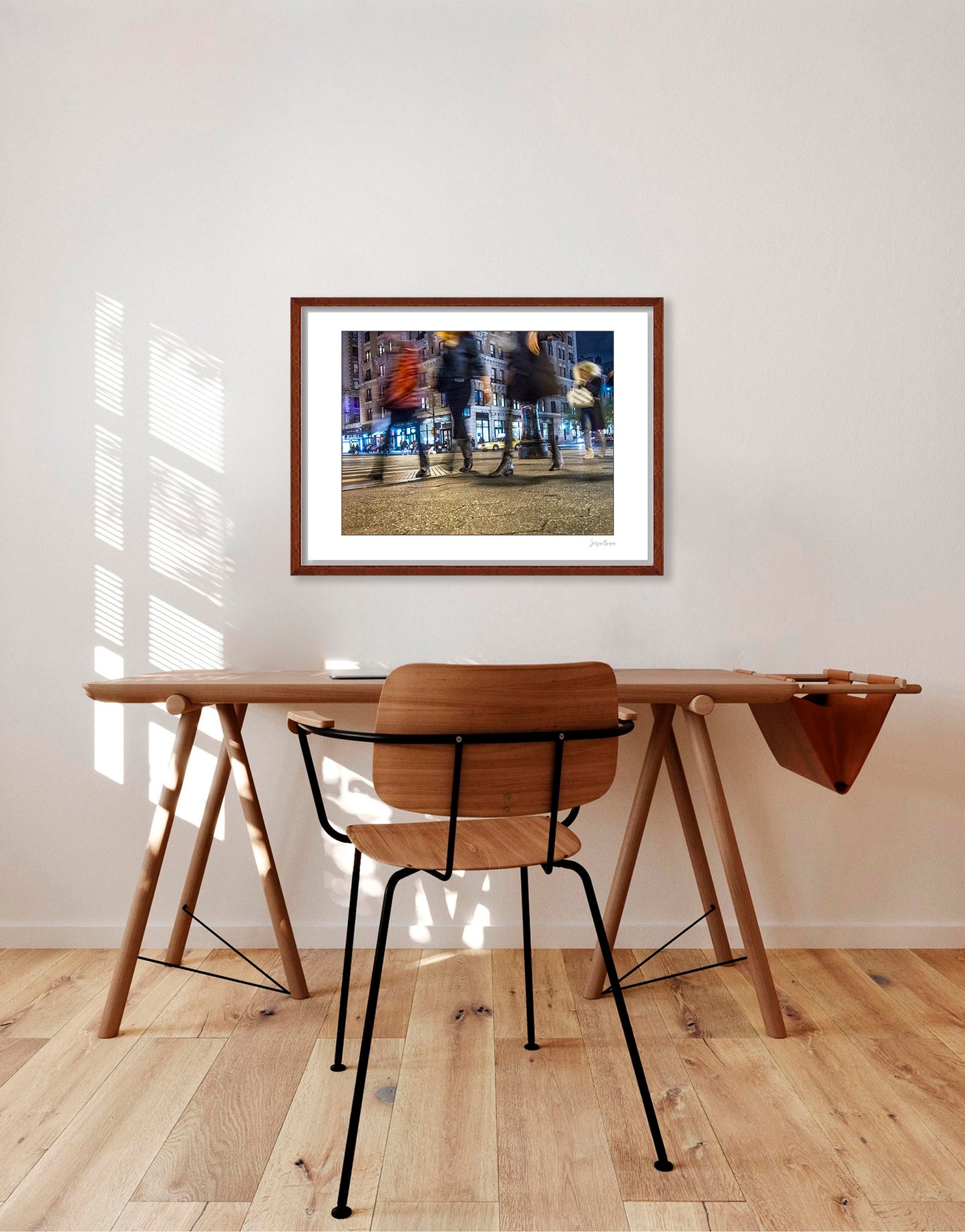 Photograph of 4 blurry people walking at night in New York City with low perspective