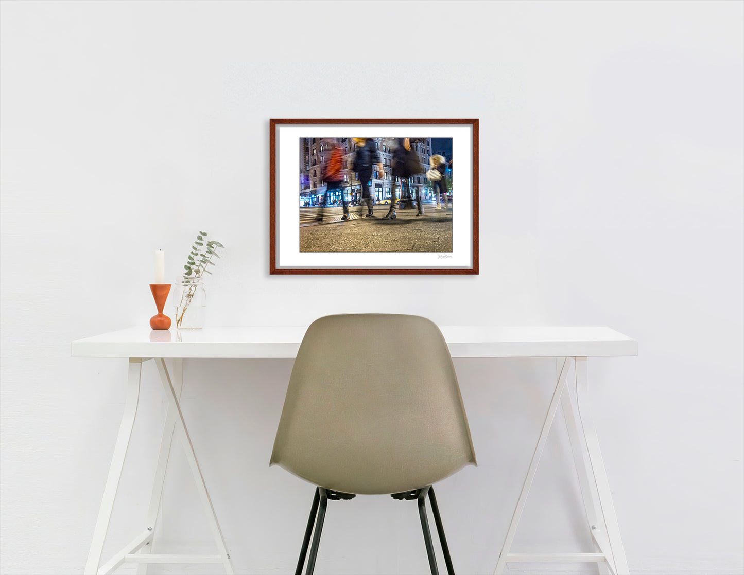 Photograph of 4 blurry people walking at night in New York City with low perspective