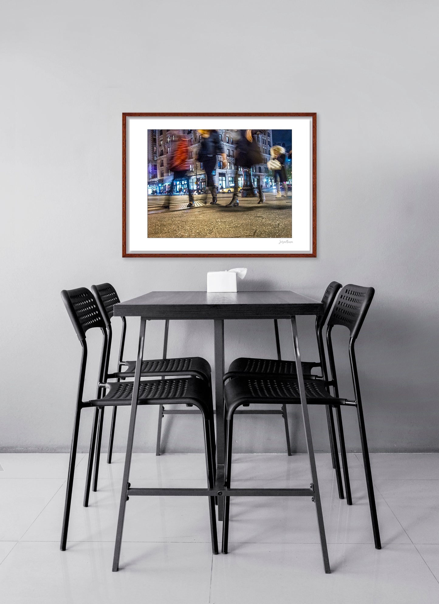 Photograph of 4 blurry people walking at night in New York City with low perspective