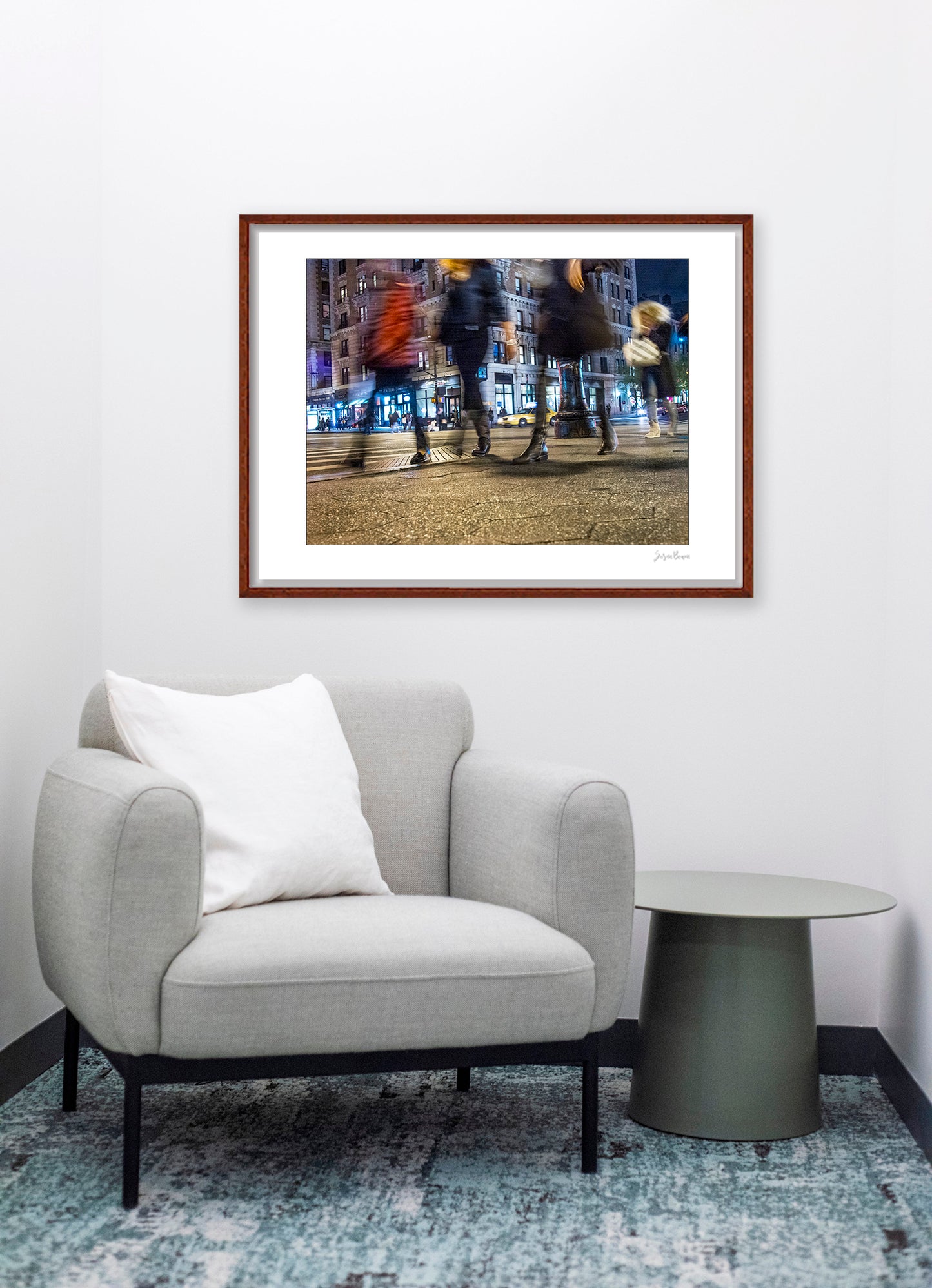 Photograph of 4 blurry people walking at night in New York City with low perspective