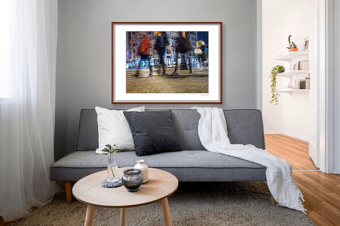 Photograph of 4 blurry people walking at night in New York City with low perspective