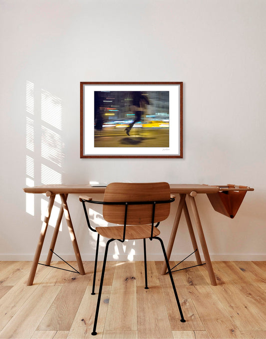 Photograph of person walking using panning technique lots of movement and color in New York City with low perspective