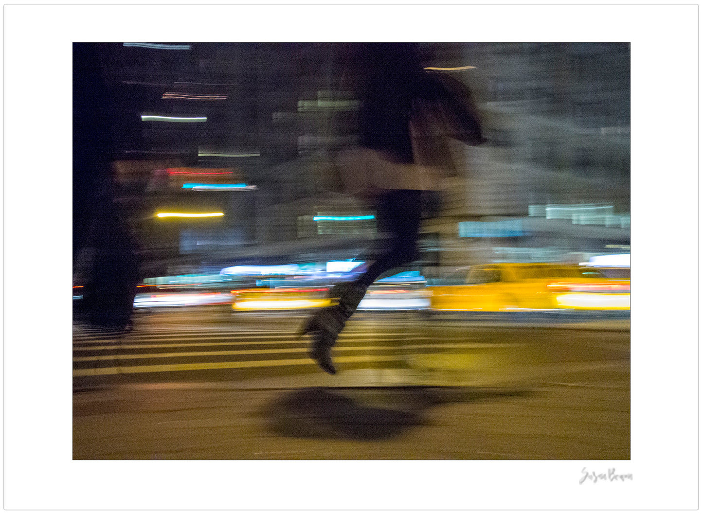 Photograph of person walking using panning technique lots of movement and color in New York City with low perspective