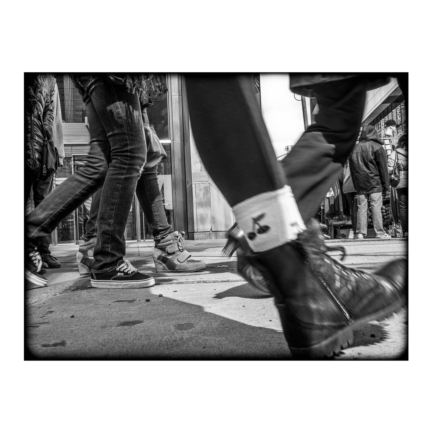 Book of black & White photographs of people walking in New York City with low perspective