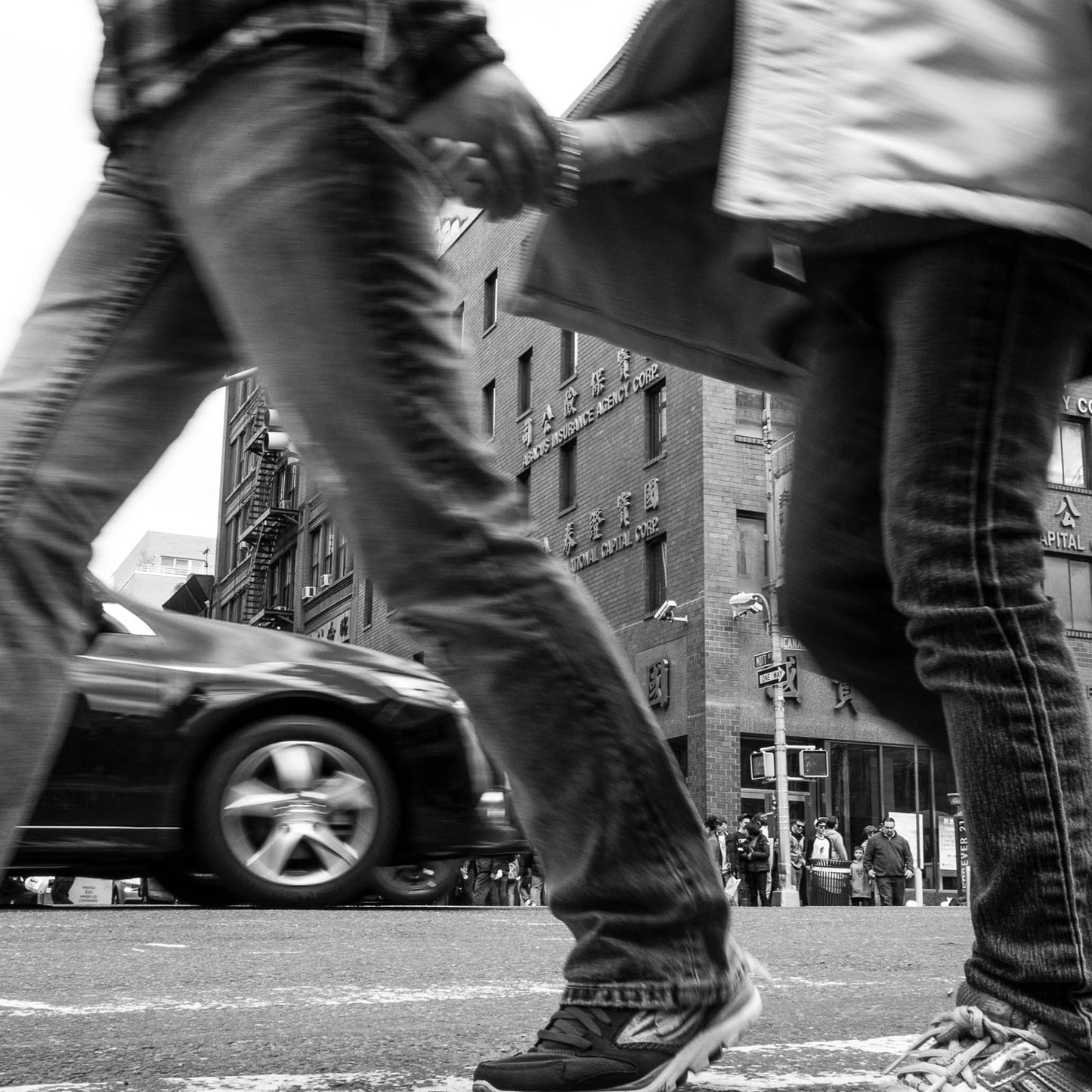 Book of black & White photographs of people walking in New York City with low perspective