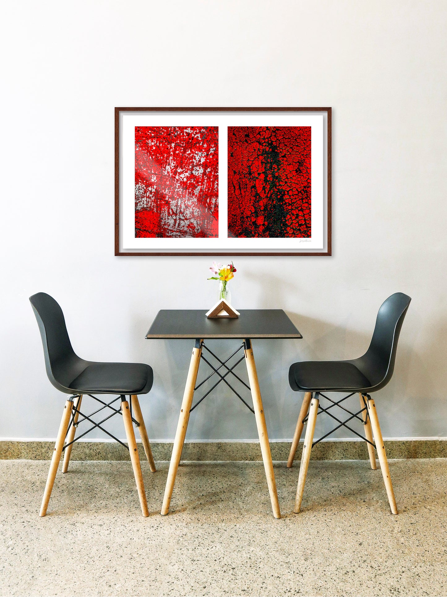 Abstract photographic diptych of highly textured surfaces in red, black, and white. Example of medium size in framed in walnut in a restaurant setting.