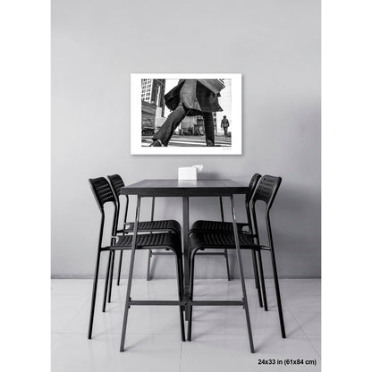 Canal Street Looming Figure artwork by Susan Bowen, shown as 24x33 print. Features low-angle B&W photograph of a figure mid-stride at Canal Street, coat billowing, dwarfing the city behind them.