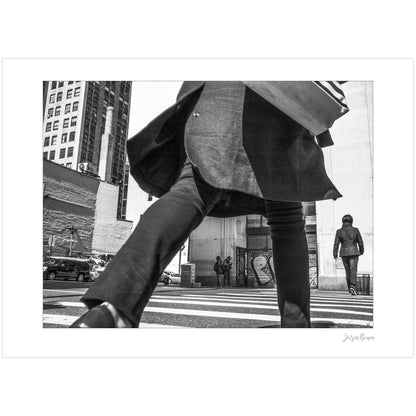 Black & White photograph of people walking in New York City with low perspective