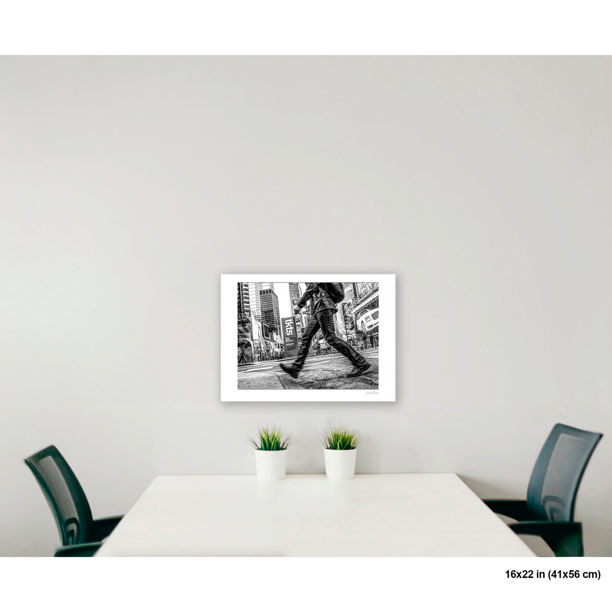 Times Square Stride artwork by Susan Bowen, shown as 16x22 print. Features B&W street photograph of a blurred stride crossing Times Square, boots and billboards in sharp contrast.