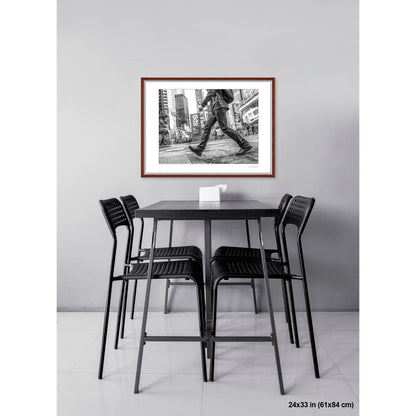 Times Square Stride artwork by Susan Bowen, shown as 24x33 framed print. Features b&W street photograph of a blurred stride crossing Times Square, boots and billboards in sharp contrast.