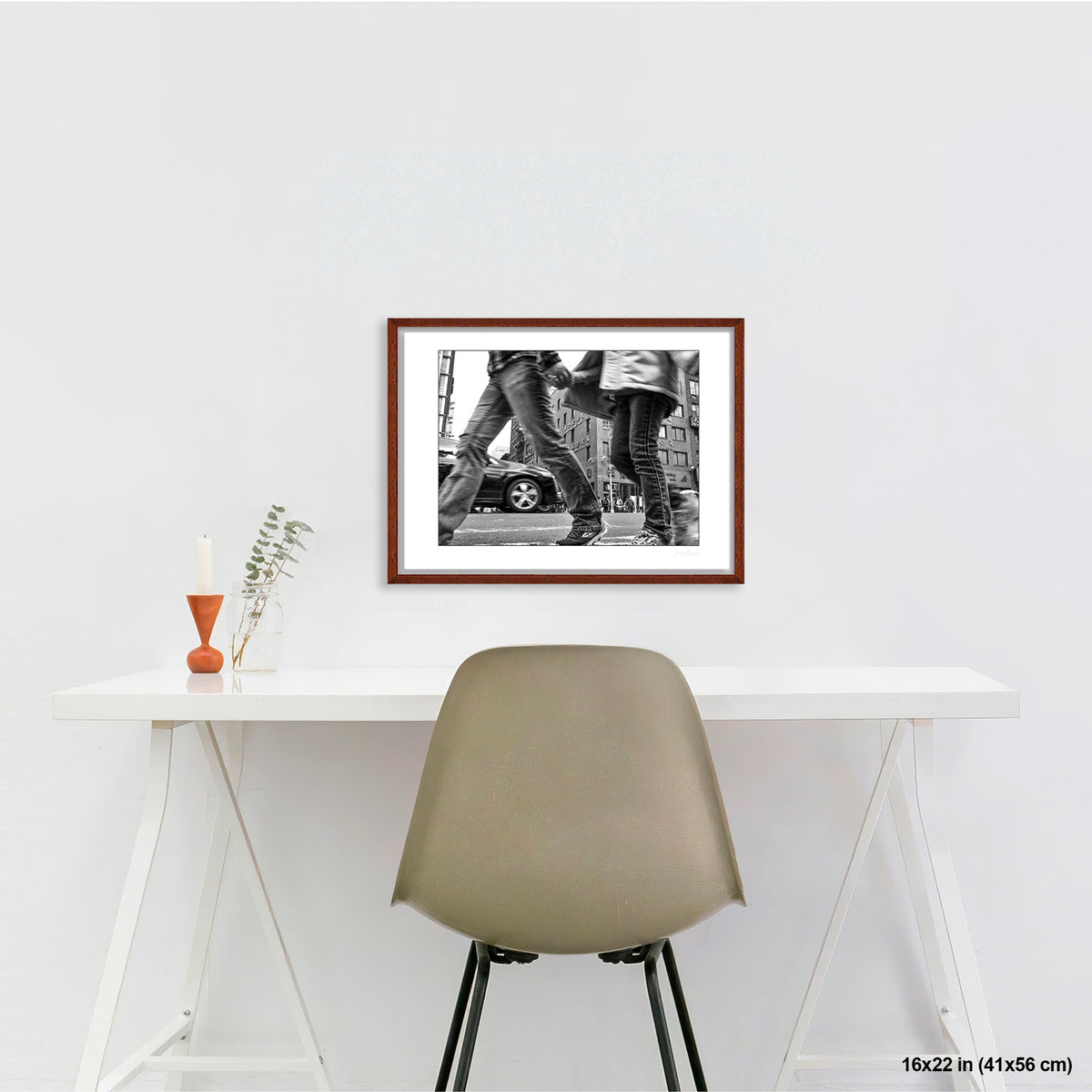 Couple in Chinatown artwork by Susan Bowen, shown as 16x22 framed print. Features low-angle B&W photograph of a couple crossing hand-in-hand through a Chinatown intersection, motion-blurred mid-stride.