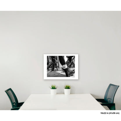 Close-up of Feet artwork by Susan Bowen, shown as 16x22 print. Features ground-level B&W photograph of multiple shoes and boots mid-step on a New York City sidewalk.