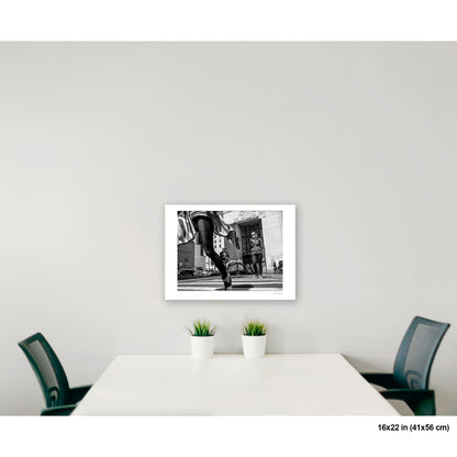 Canal Street, Waving Dress artwork by Susan Bowen, shown as 16x22 print. Features B&W low-angle photograph of a woman in a striped dress mid-stride on a Canal Street crosswalk, skirt in motion.