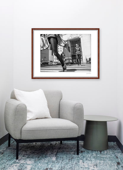 Black & White photograph of people walking in New York City with low perspective