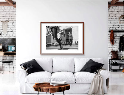 Black & White photograph of people walking in New York City with low perspective