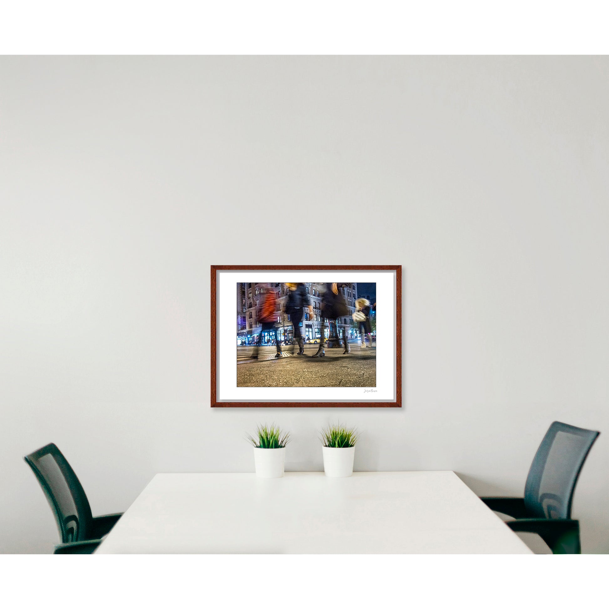 Photograph of 4 blurry people walking at night in New York City with low perspective