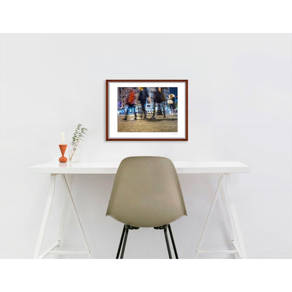 Photograph of 4 blurry people walking at night in New York City with low perspective