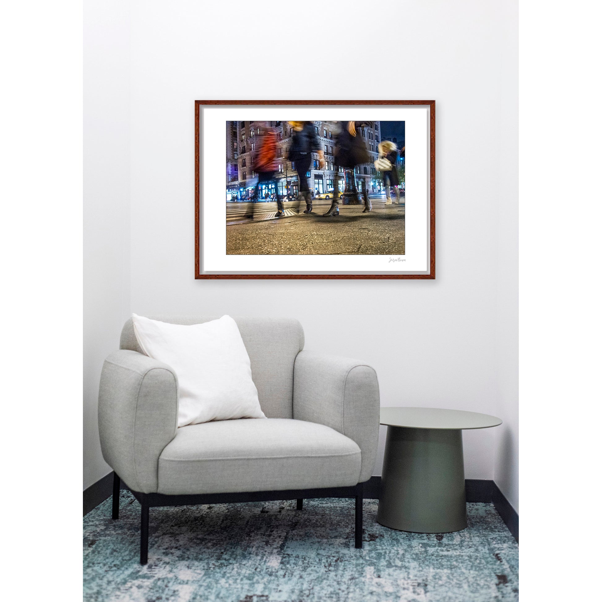 Photograph of 4 blurry people walking at night in New York City with low perspective