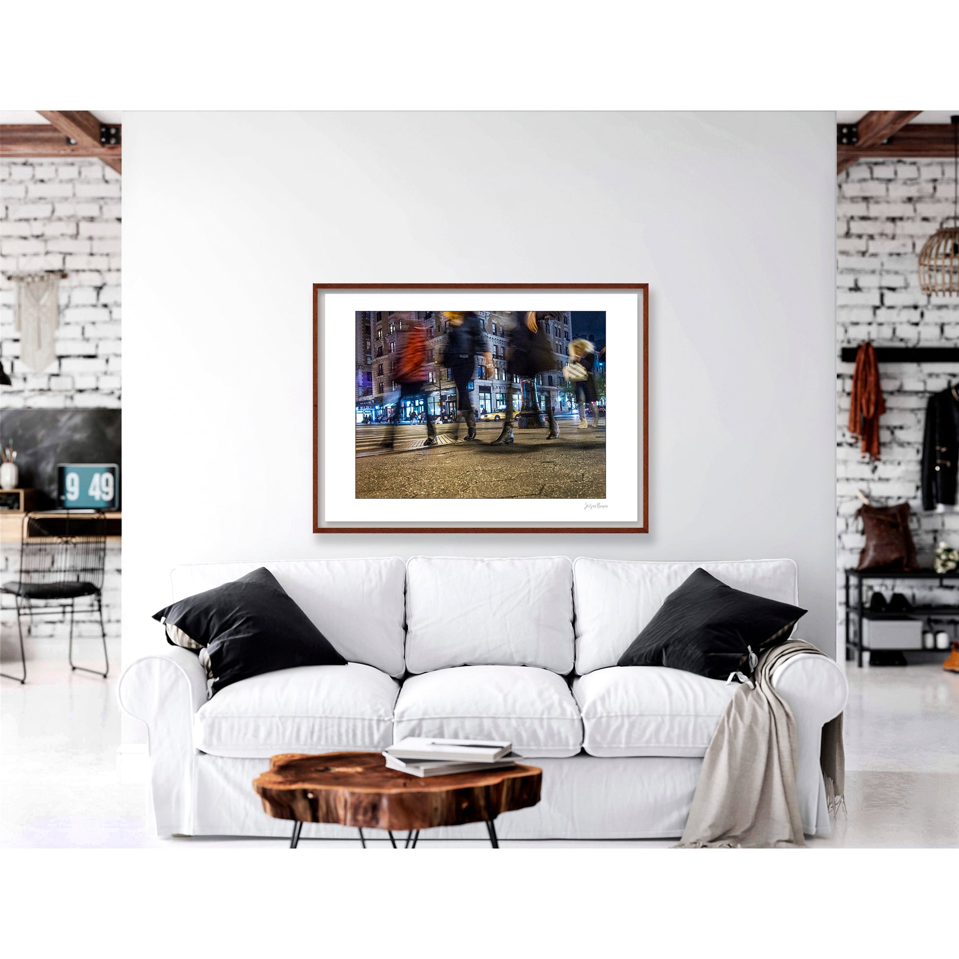 Photograph of 4 blurry people walking at night in New York City with low perspective