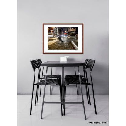 Foot Near Curb and Headlights artwork by Susan Bowen, shown as 24x33 framed print. Features long-exposure night photograph of a single shoe on a wet Canal Street crosswalk, surrounded by streaking headlights.
