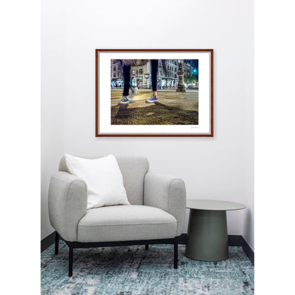Photograph of two mis-matched legs of different people at night in New York City with low perspective
