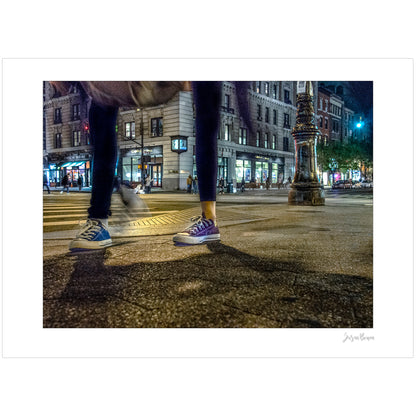 Photograph of two mis-matched legs of different people at night in New York City with low perspective