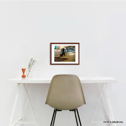 High-Heeled Shoe and Bus artwork by Susan Bowen, shown as 11x15 framed print. Features long-exposure night photograph of a single high-heeled shoe on a NYC crosswalk as a city bus streaks past behind it.
