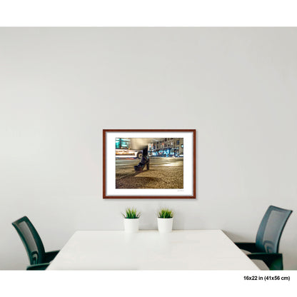 High-Heeled Shoe and Bus artwork by Susan Bowen, shown as 16x22 framed print. Features long-exposure night photograph of a single high-heeled shoe on a NYC crosswalk as a city bus streaks past behind it.