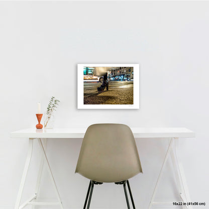 High-Heeled Shoe and Bus artwork by Susan Bowen, shown as 16x22 print. Features long-exposure night photograph of a single high-heeled shoe on a NYC crosswalk as a city bus streaks past behind it.