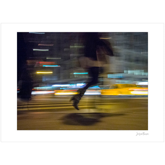 Photograph of person walking using panning technique lots of movement and color in New York City with low perspective