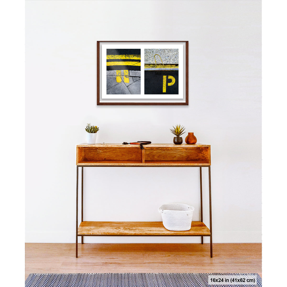 Yellow Markings and 'P' artwork by Susan Bowen, shown as 16x24 framed print. Features double yellow lines and a painted 'P' paired as bold, graphic urban street photography.