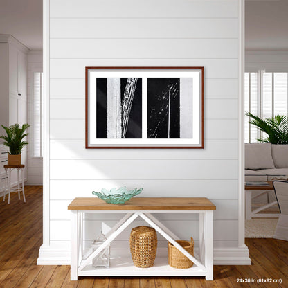 Uncontrolled White artwork by Susan Bowen, shown as 24x36 framed print. Features skewed white road stripes and tire marks capture the tension between order and accident on asphalt.