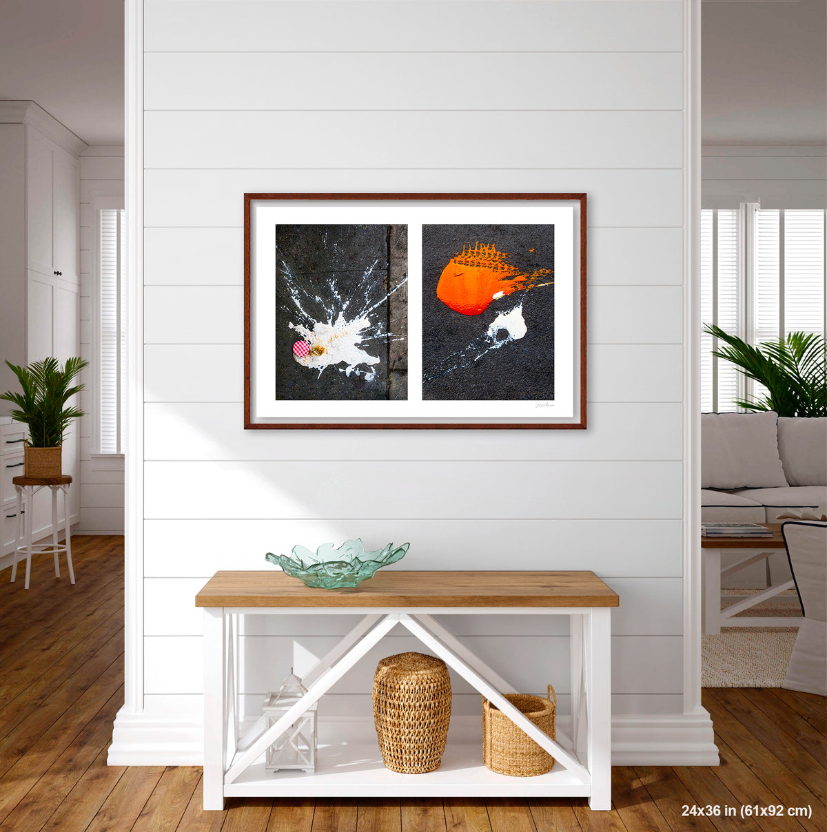 Dropped Cream and Orange Glob artwork by Susan Bowen, shown as 24x36 framed print. Features abstract diptych pairing a radiant white splatter with a bold orange paint spill on city pavement, two accidental forms in vivid contrast.