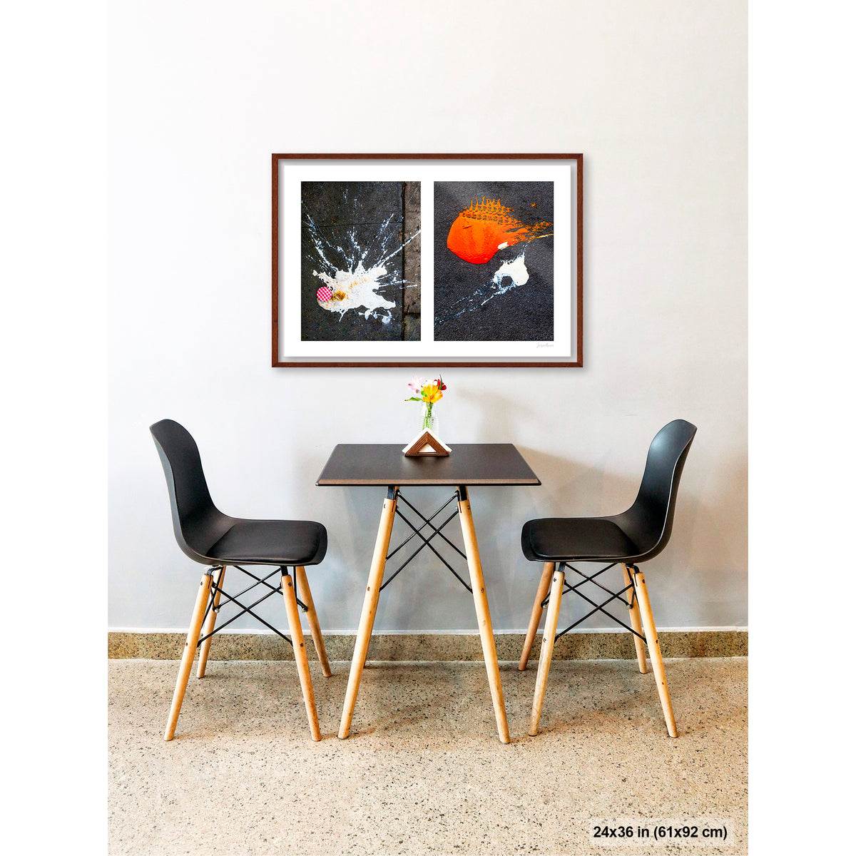 Dropped Cream and Orange Glob artwork by Susan Bowen, shown as 24x36 framed print. Features abstract diptych pairing a radiant white splatter with a bold orange paint spill on city pavement, two accidental forms in vivid contrast.